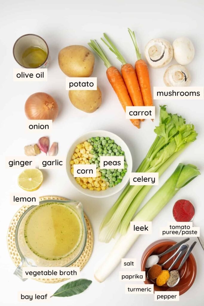 ingredients for golden veggie soup including carrots, potatoes, onion, garlic, turmeric, and broth
