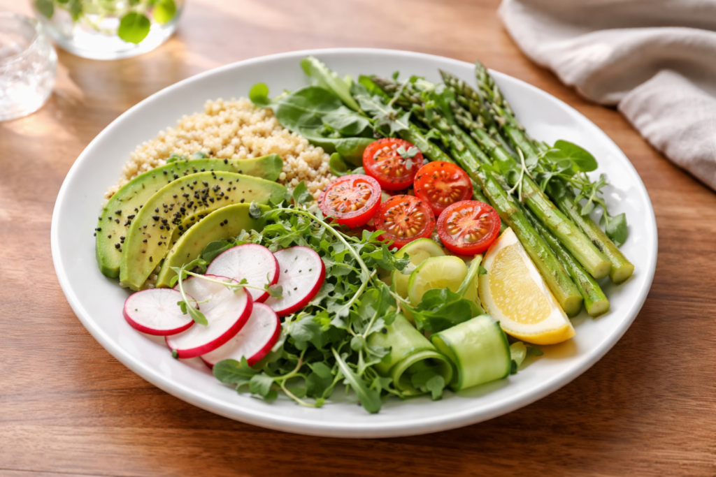 easy spring meal with greens grains and vegetables on a wooden countertop in natural light