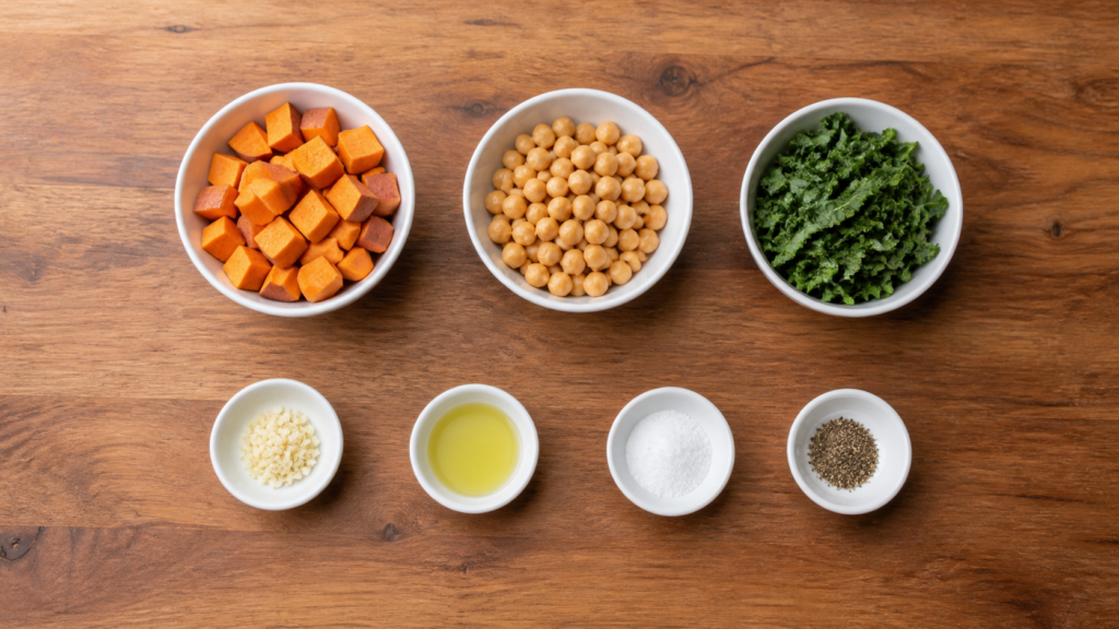 Small white bowls with sweet potatoes, chickpeas, greens, garlic, and seasonings arranged simple breakfast ingredients for a savory breakfast.
