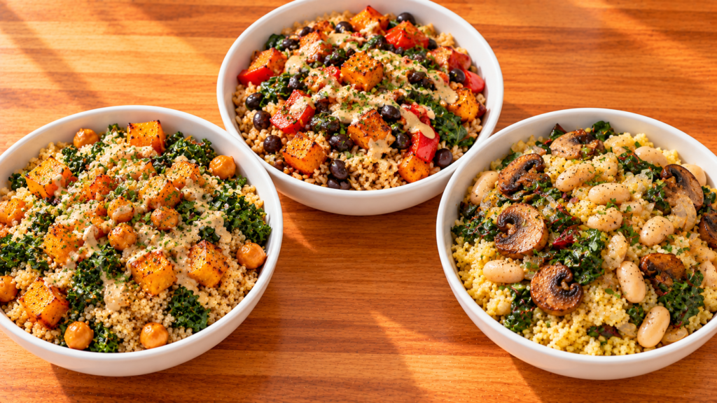 Three warm fall grain bowls with cooked grains, beans, roasted vegetables, greens, and flavorful dressings.